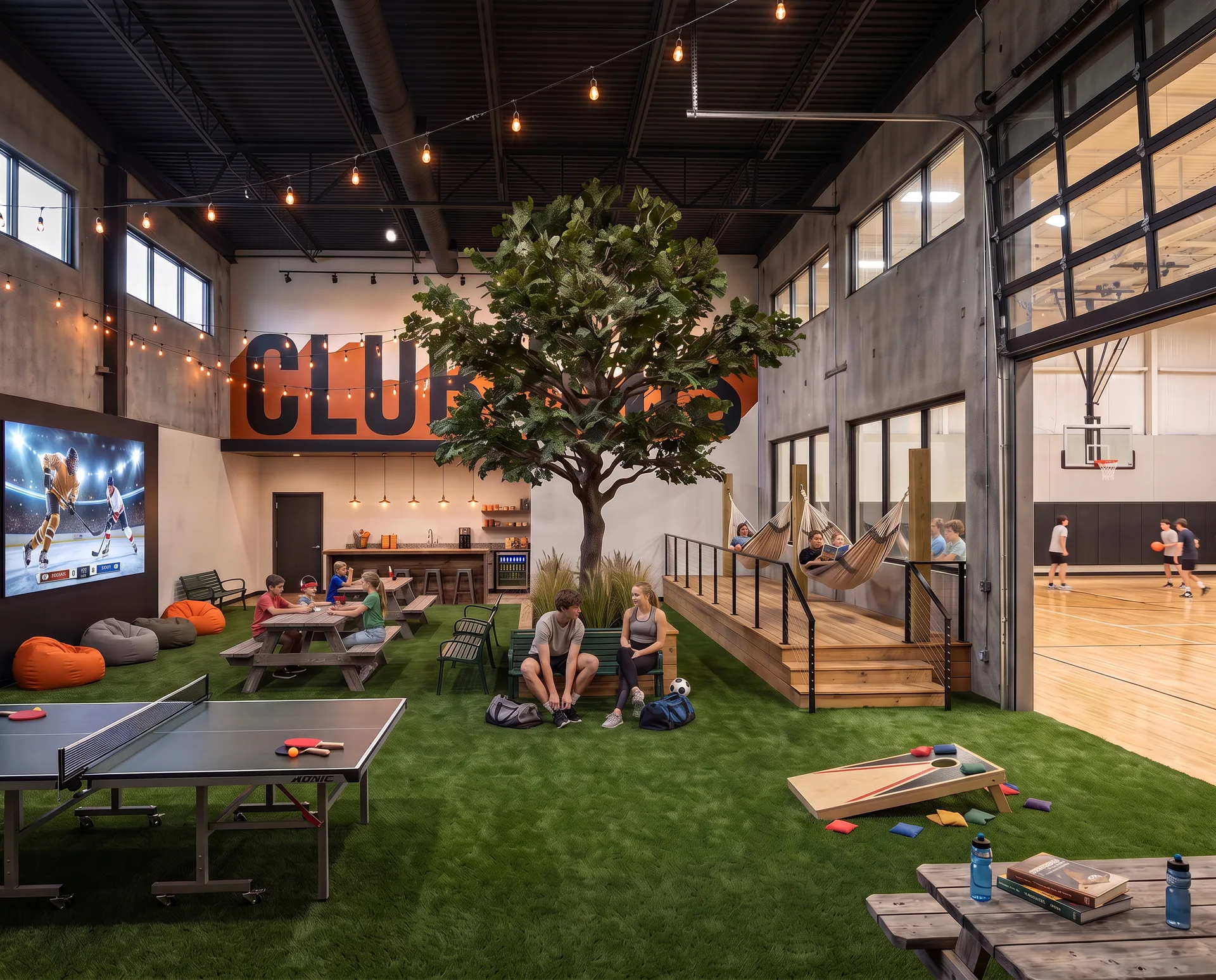 Rendering of the Club Haus at HAUS Salem: an indoor tree on turf surrounded by picnic tables and benches, hammocks on a raised deck, bean bags and a movie wall showing a hockey game, ping-pong, cornhole, a snack bar, and a basketball court through an open glass garage door