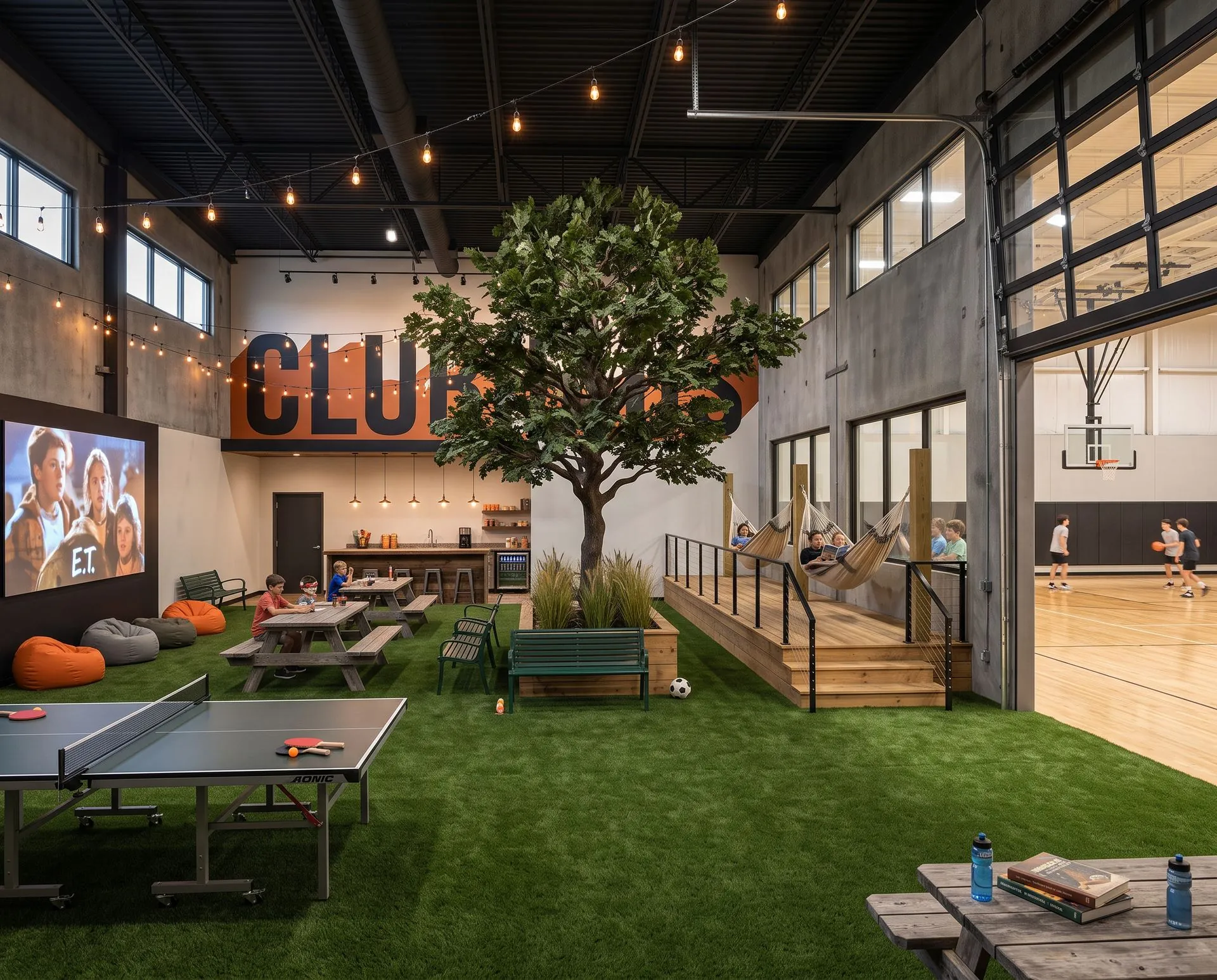 Rendering of the Club Haus at HAUS Salem: an indoor tree on turf surrounded by picnic tables, hammocks on a raised deck, bean bags and a movie wall, ping-pong, a snack bar, and a basketball court through an open glass garage door